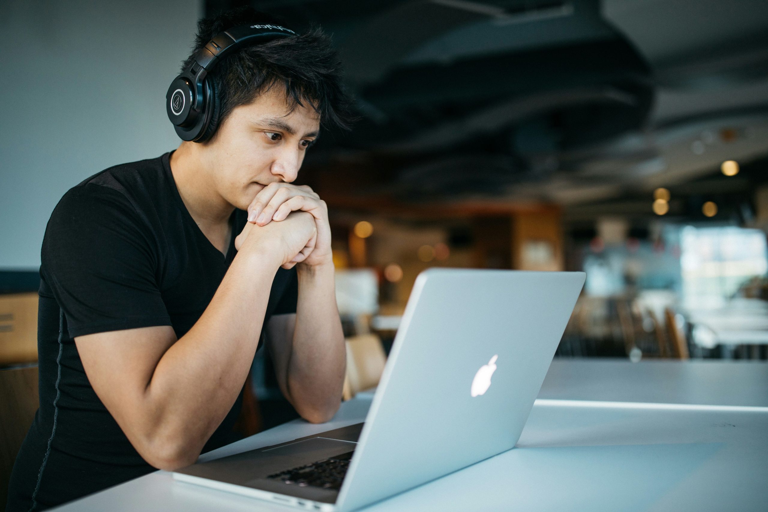 A Student looking at his laptop.